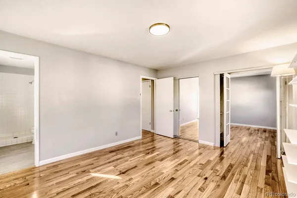 a view of a room with wooden floor