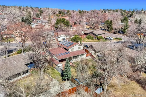 a view of a house with a yard and mountains in the background