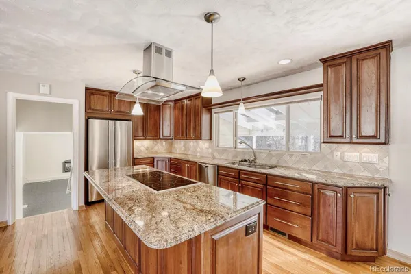 a kitchen with stainless steel appliances granite countertop a sink stove and refrigerator