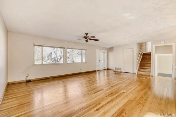 wooden floor in an empty room with a window
