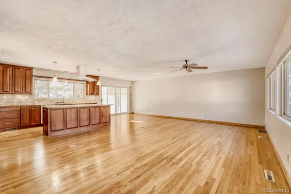 a view of a kitchen with wooden floor and a kitchen