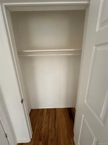 a view of walk in closet with wooden floor