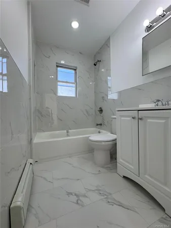 a view of bathroom with bathtub and toilet