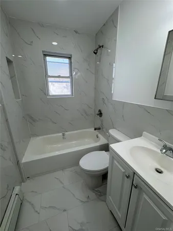 a bathroom with a sink mirror toilet and bathtub