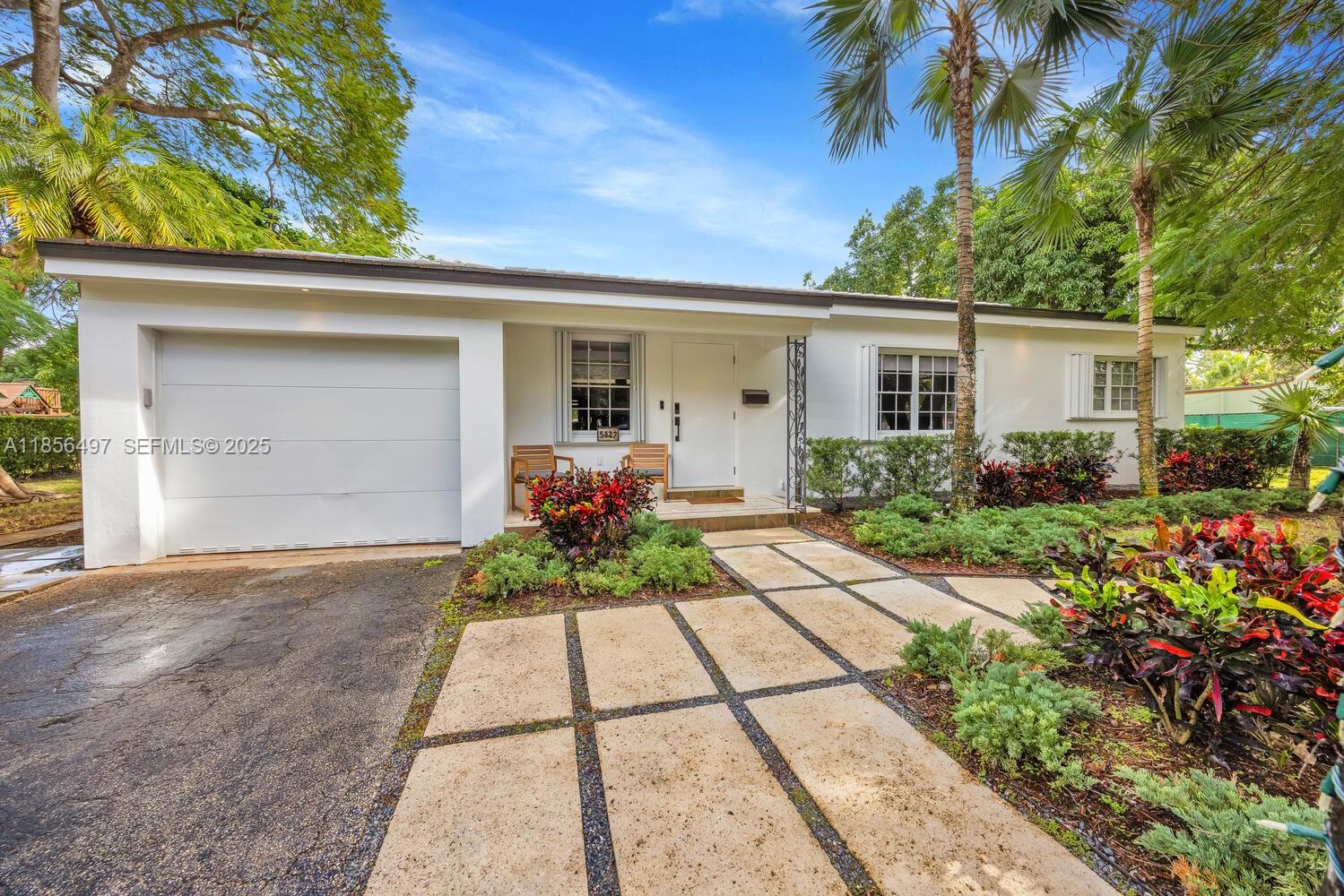 5827 Southwest 69th Court Miami, FL 33143 - Photo 1 of 18 a front view of a house with garden