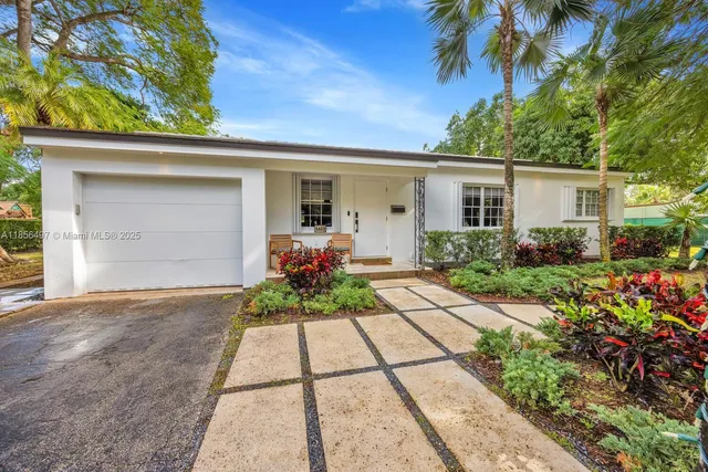 a front view of a house with garden