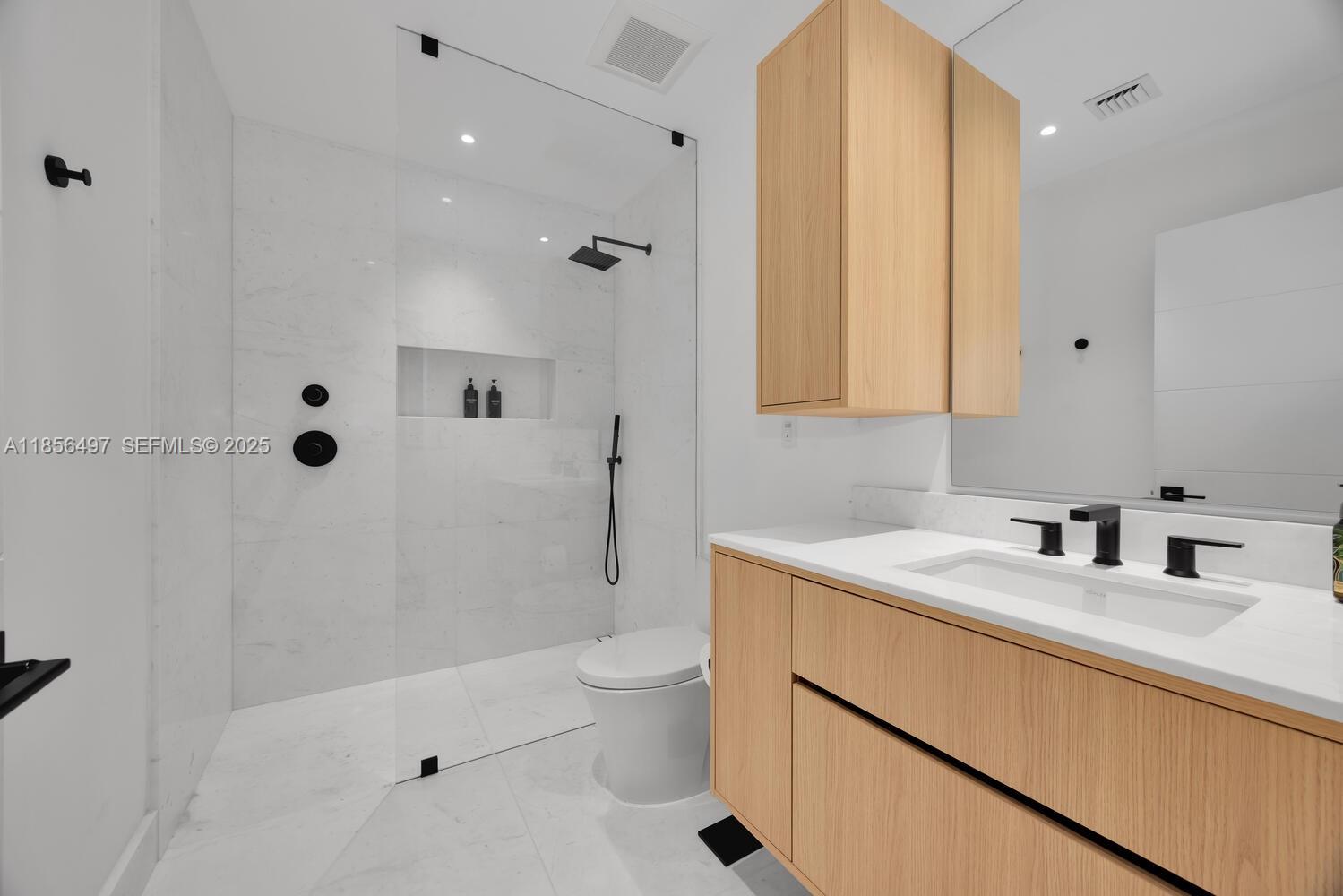 5827 Southwest 69th Court Miami, FL 33143 - Photo 13 of 18 a bathroom with a sink a toilet and shower