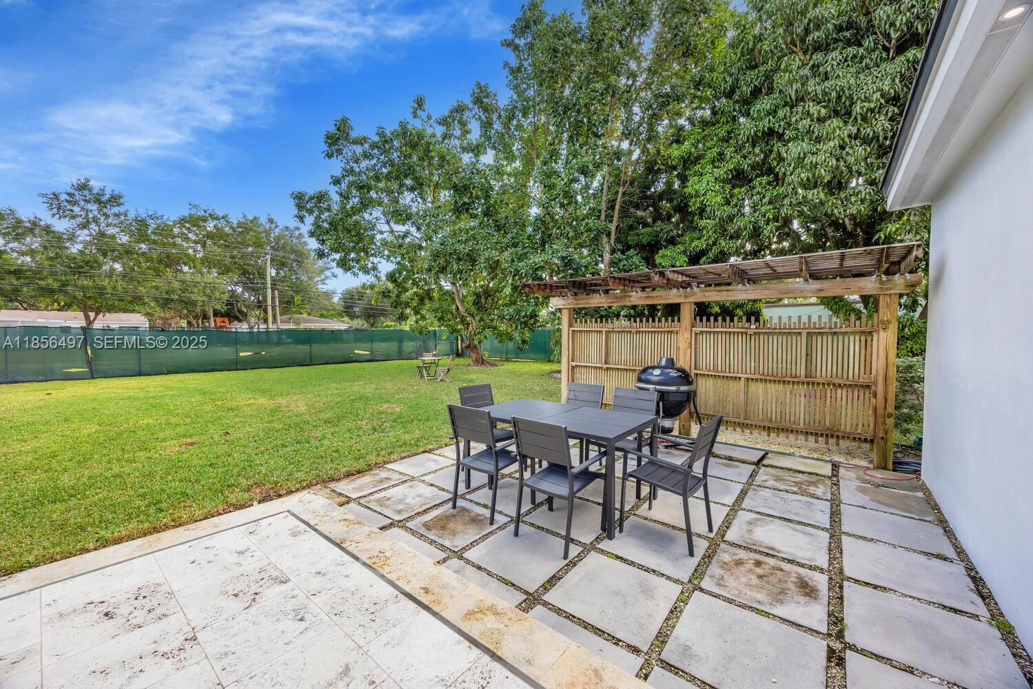 5827 Southwest 69th Court Miami, FL 33143 - Photo 16 of 18 a view of a backyard with sitting area furniture and garden