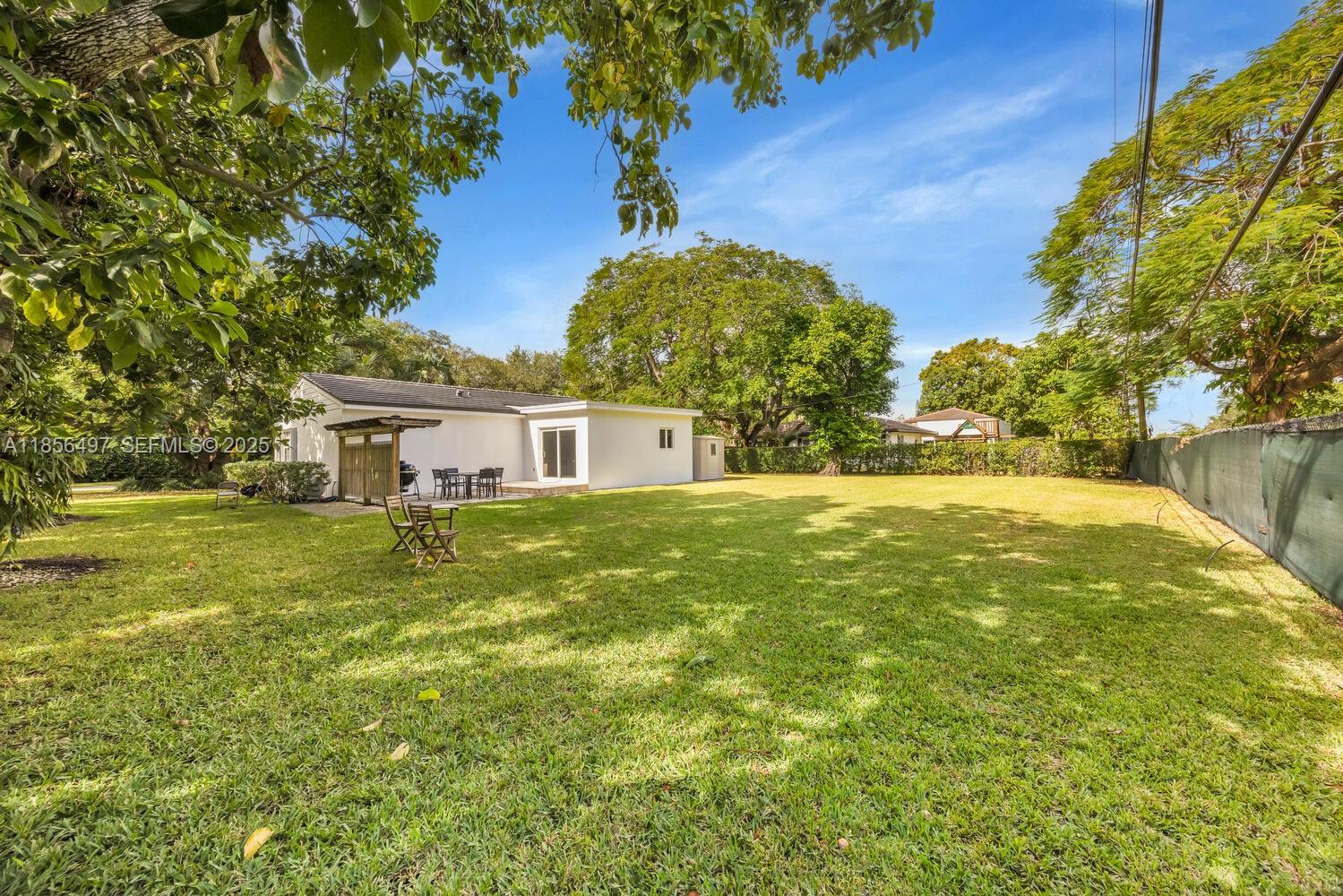 5827 Southwest 69th Court Miami, FL 33143 - Photo 17 of 18 a front view of house with yard and trees