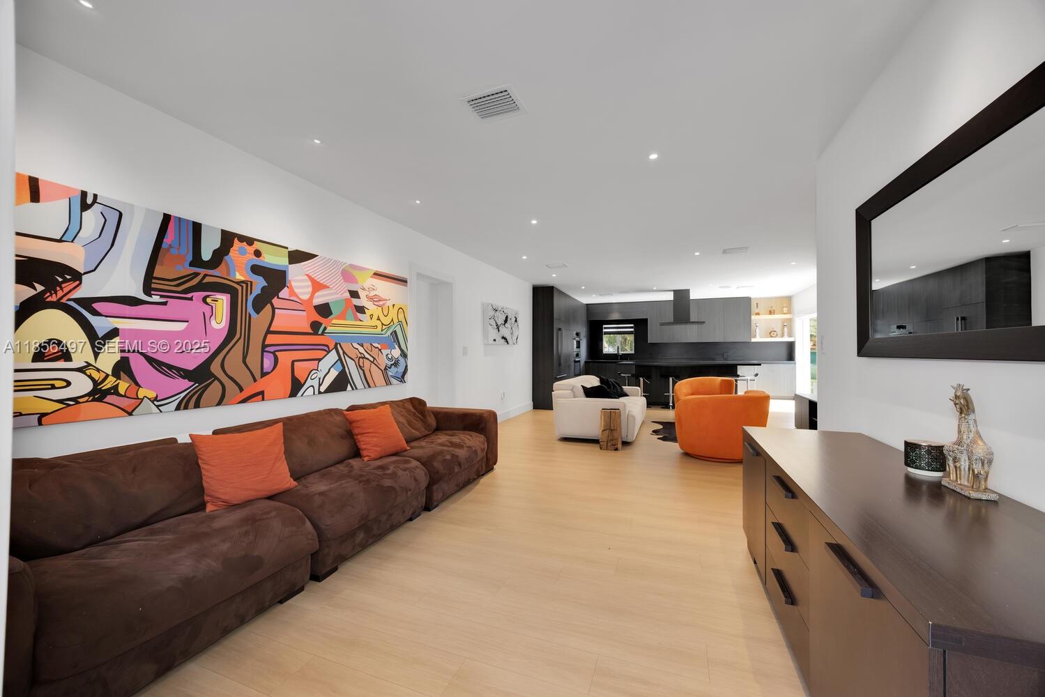 5827 Southwest 69th Court Miami, FL 33143 - Photo 2 of 18 a living room with furniture and a flat screen tv