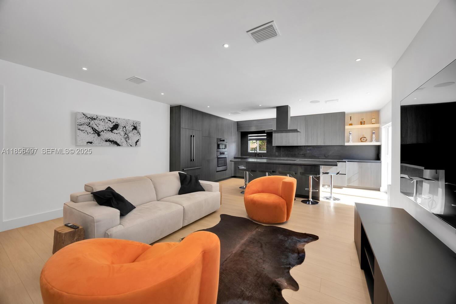 5827 Southwest 69th Court Miami, FL 33143 - Photo 4 of 18 a living room with furniture and a flat screen tv