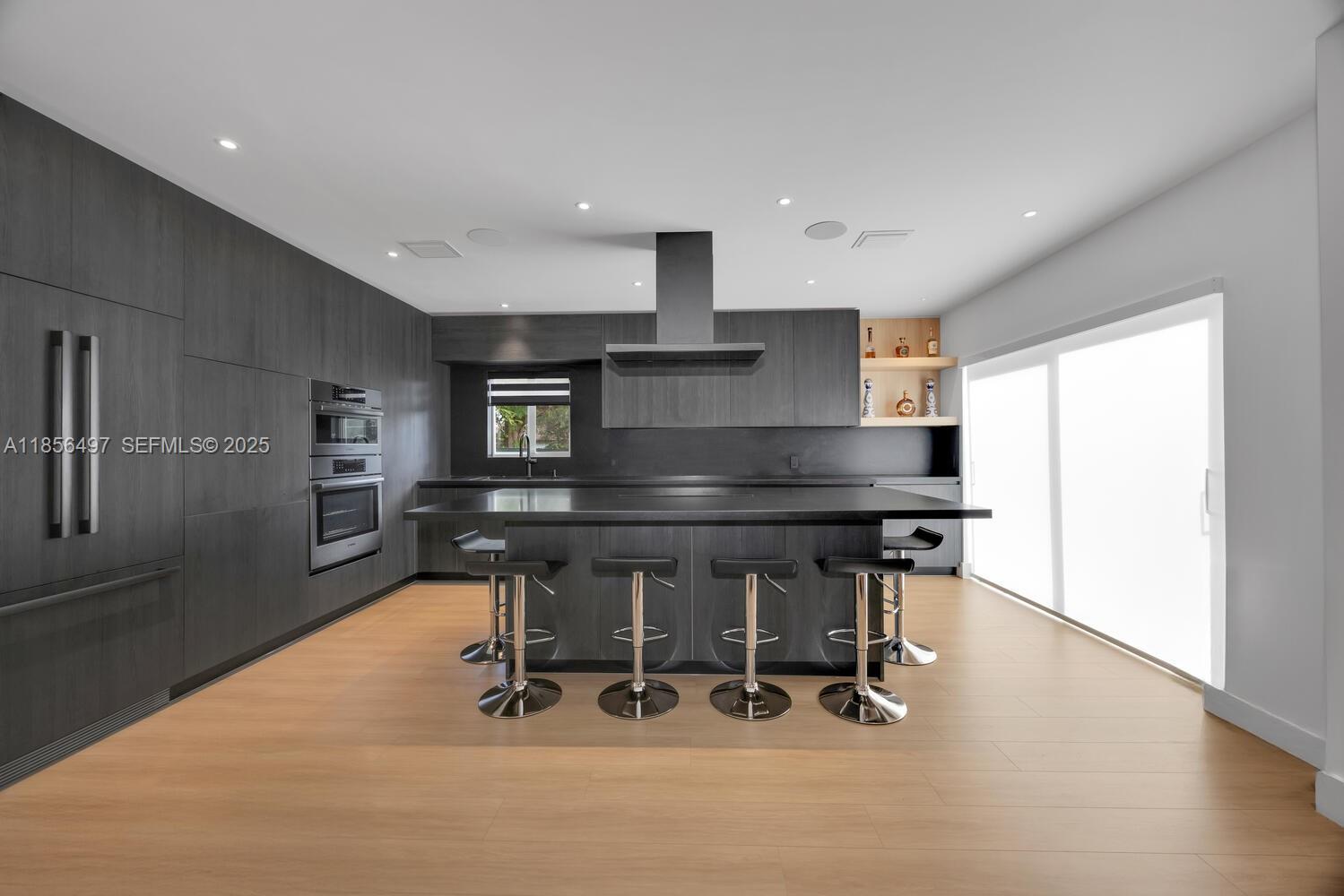 5827 Southwest 69th Court Miami, FL 33143 - Photo 7 of 18 a kitchen with a table chairs sink and refrigerator