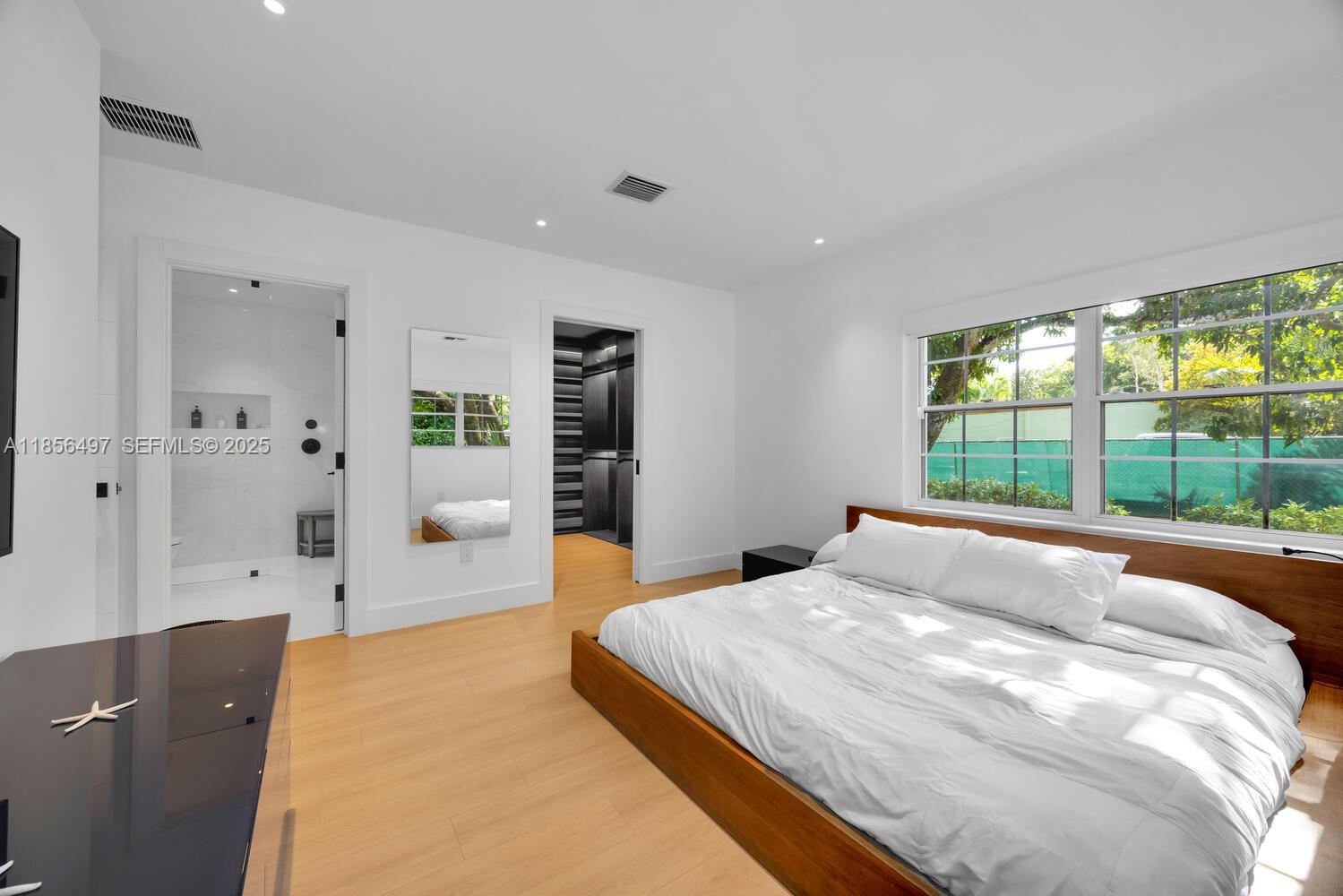 5827 Southwest 69th Court Miami, FL 33143 - Photo 9 of 18 a spacious bedroom with a large bed and a large window