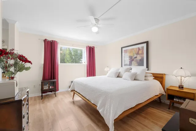 a bedroom with a bed and a potted plant
