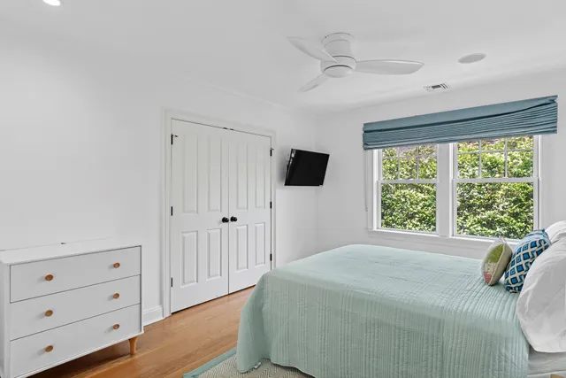 a spacious bedroom with a bed and a window