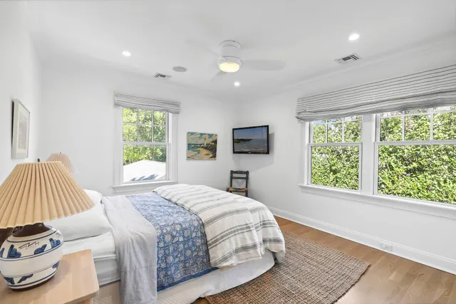 a bedroom with a bed and a large window