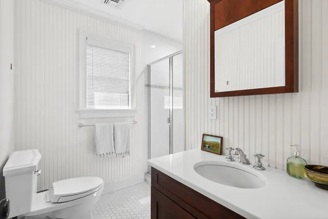 a bathroom with a sink toilet a mirror and vanity