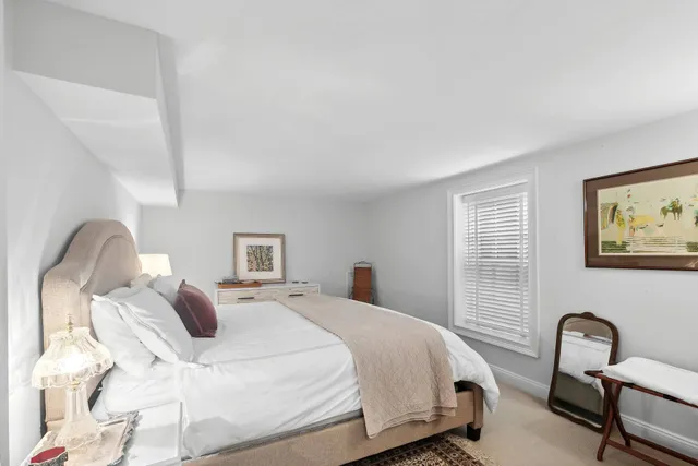 a bedroom with a bed and a chair