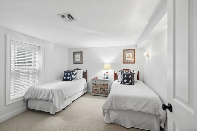 a bedroom with two beds and painted walls