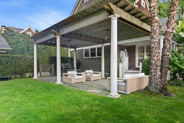 a view of a house with backyard sitting area and garden