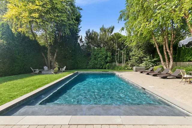 a view of a backyard with large trees
