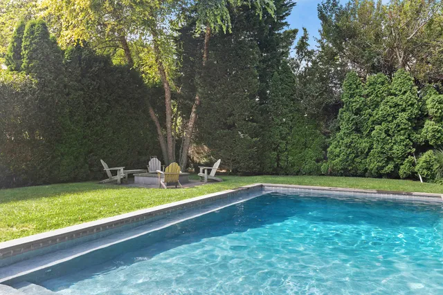 a view of a swimming pool with an outdoor space and seating area