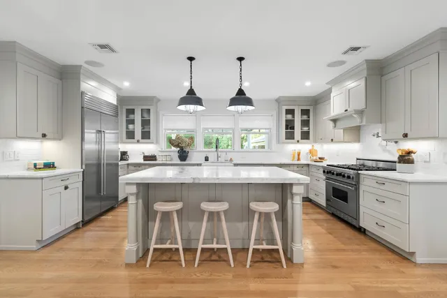 a kitchen with stainless steel appliances a sink and cabinets