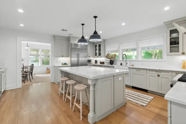 a kitchen with stainless steel appliances granite countertop a sink stove and wooden floor