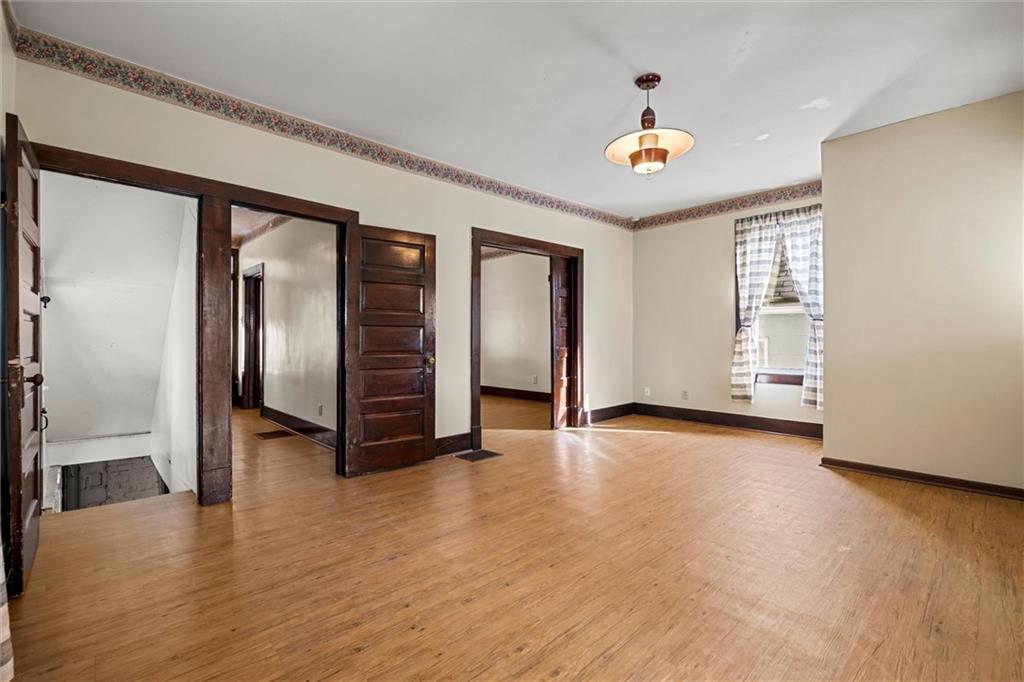 325 Walnut Street Vandergrift, PA 15690 - Photo 7 of 29 wooden floor in an empty room with a window