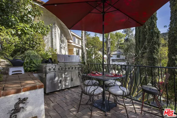 a backyard of a house with table and chairs