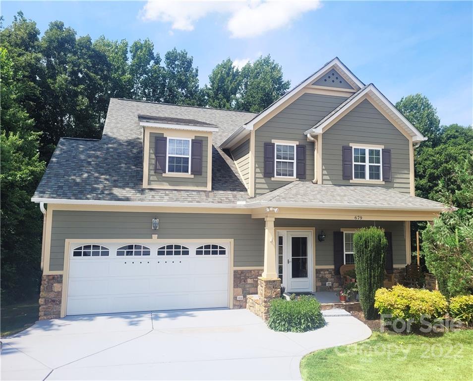 679 Presbyterian Road Mooresville, NC 28115 - Photo 1 of 25 a front view of a house with garden
