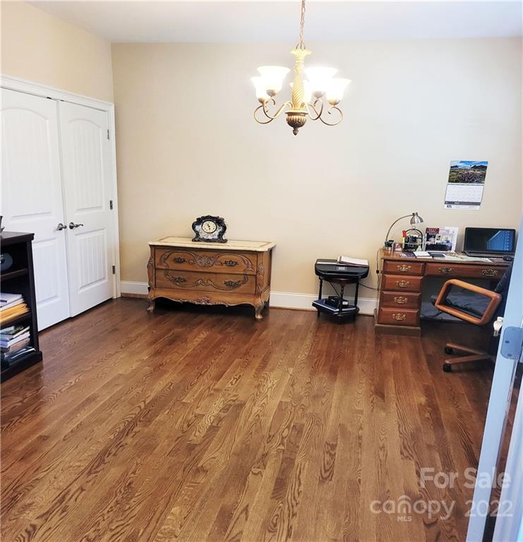679 Presbyterian Road Mooresville, NC 28115 - Photo 12 of 25 a view of a livingroom with furniture a chandelier and wooden floor