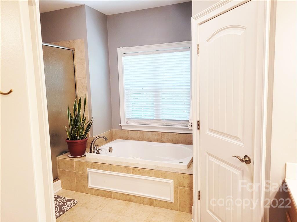 679 Presbyterian Road Mooresville, NC 28115 - Photo 8 of 25 a bathroom with a bathtub and a shower