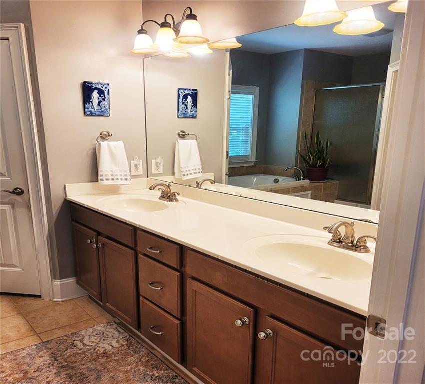 679 Presbyterian Road Mooresville, NC 28115 - Photo 9 of 25 a bathroom with a sink and a mirror