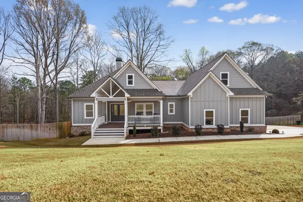 a front view of a house with a yard outdoor seating and garage