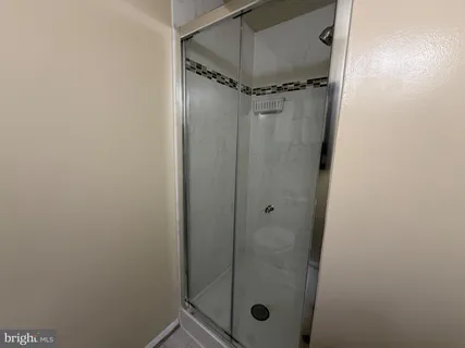 a bathroom with a glass door shower