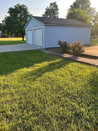a front view of house with yard and swimming pool