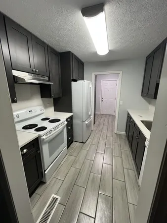 a kitchen with a sink a refrigerator and washer
