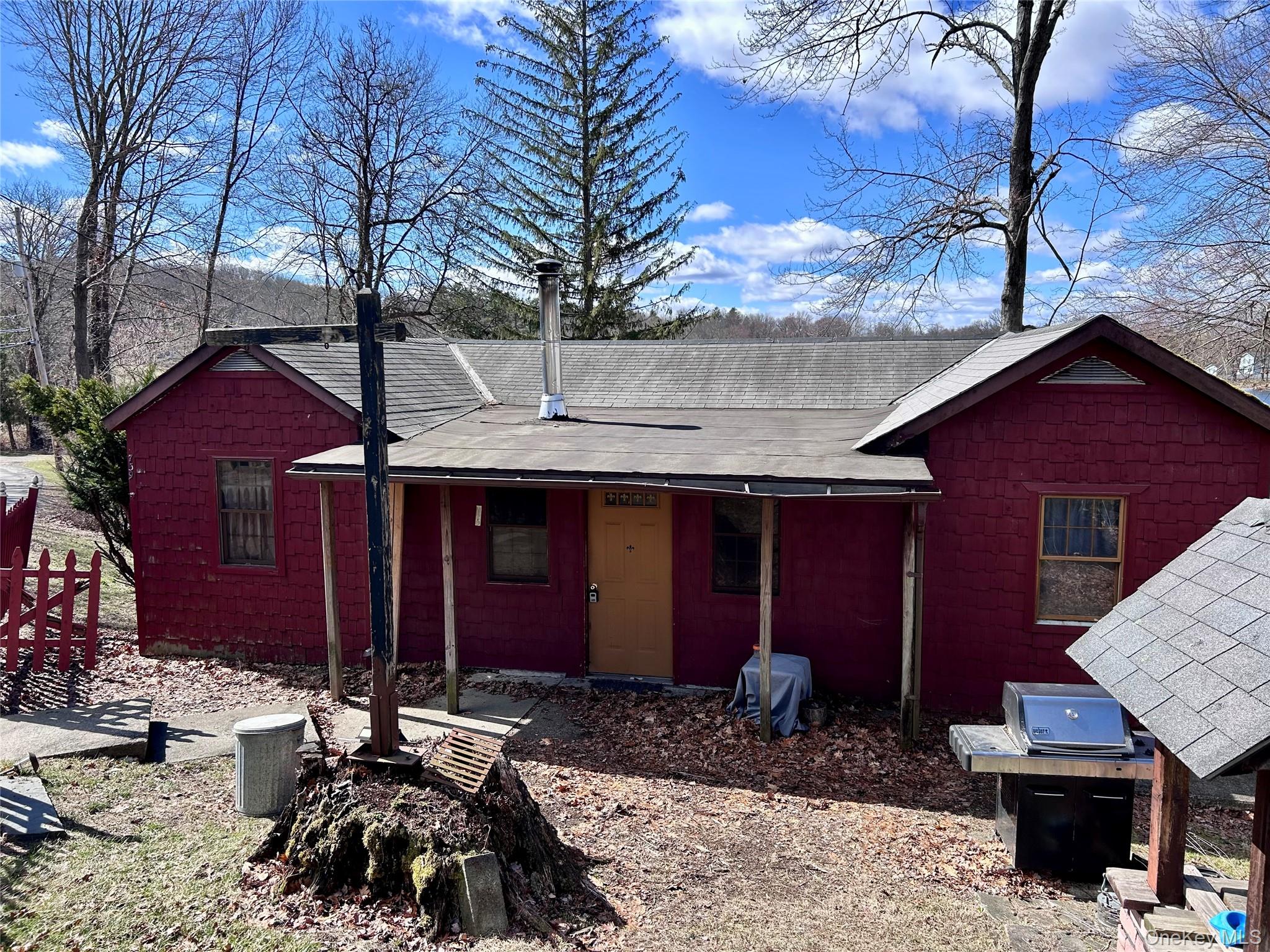 a couple of table and chairs in front of house
