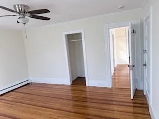a view of an empty room with wooden floor