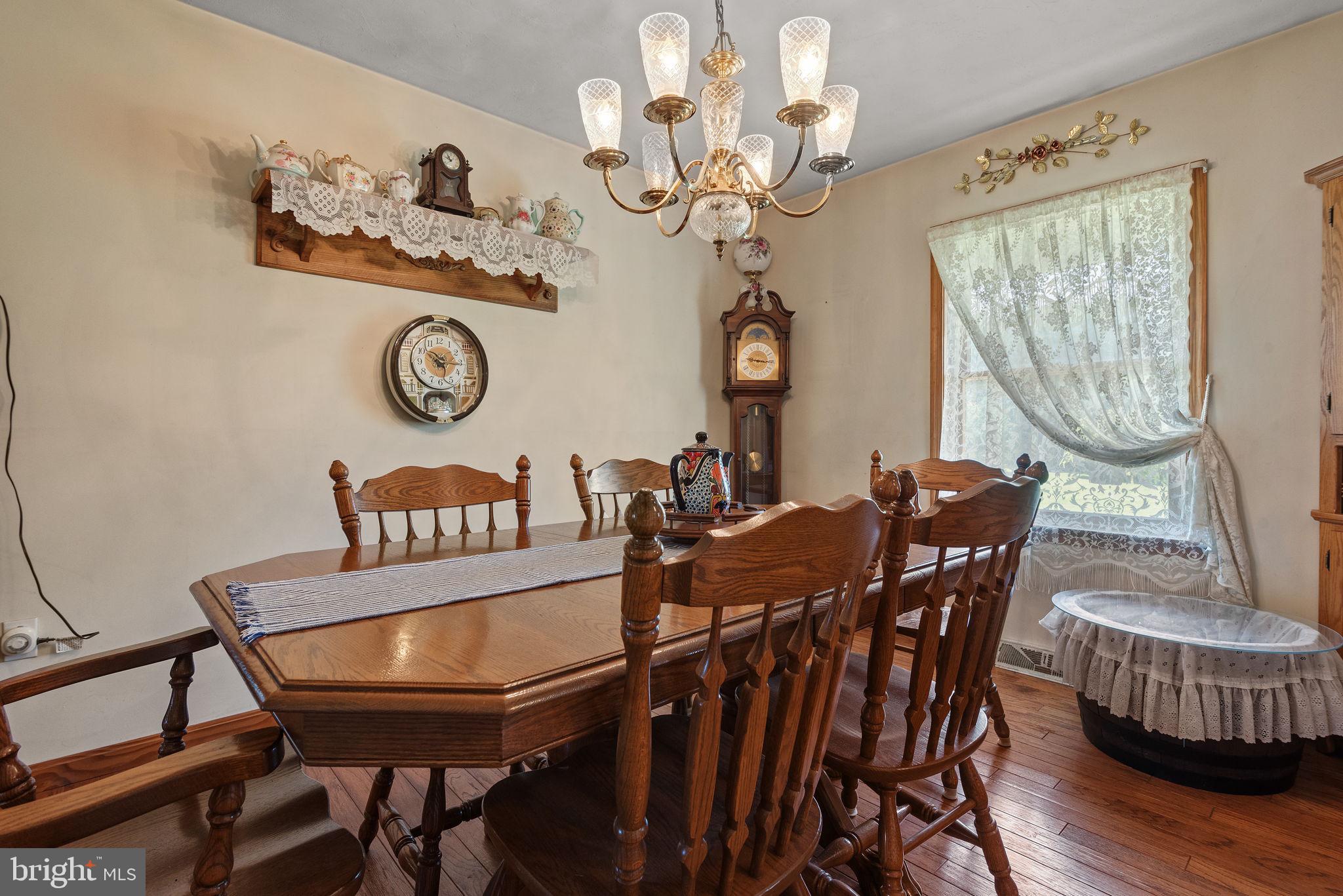 5363 Waltersdorff Road Spring Grove, PA 17362 - Photo 14 of 66 a view of a dining room with furniture a chandelier and wooden floor