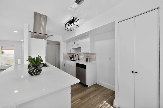 a kitchen with a white refrigerator and a stove