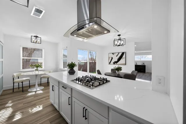 a kitchen with a table and chairs