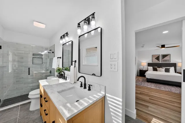 a en suite bathroom with a sink and a mirror