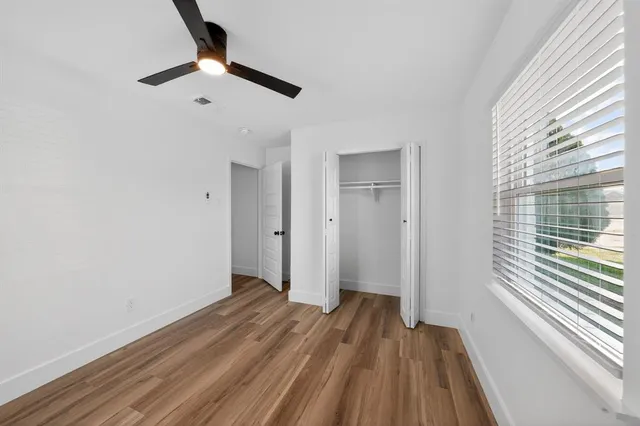 a view of a room with wooden floor cabinets and a window