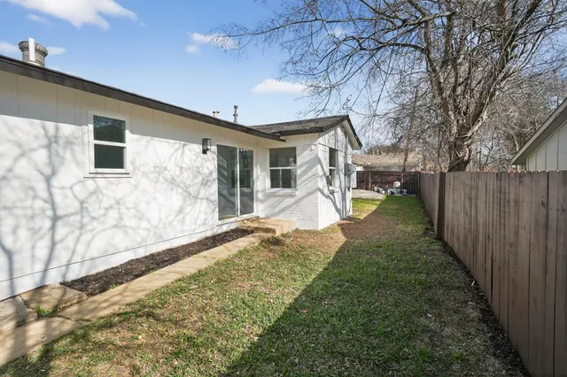 a view of a backyard with a tree