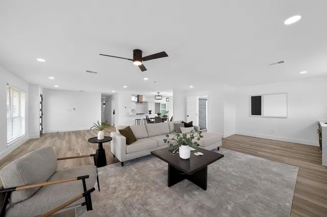 a living room with furniture and view of kitchen