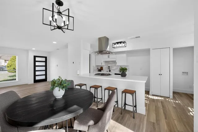 a view of a dining room with furniture wooden floor and chandelier
