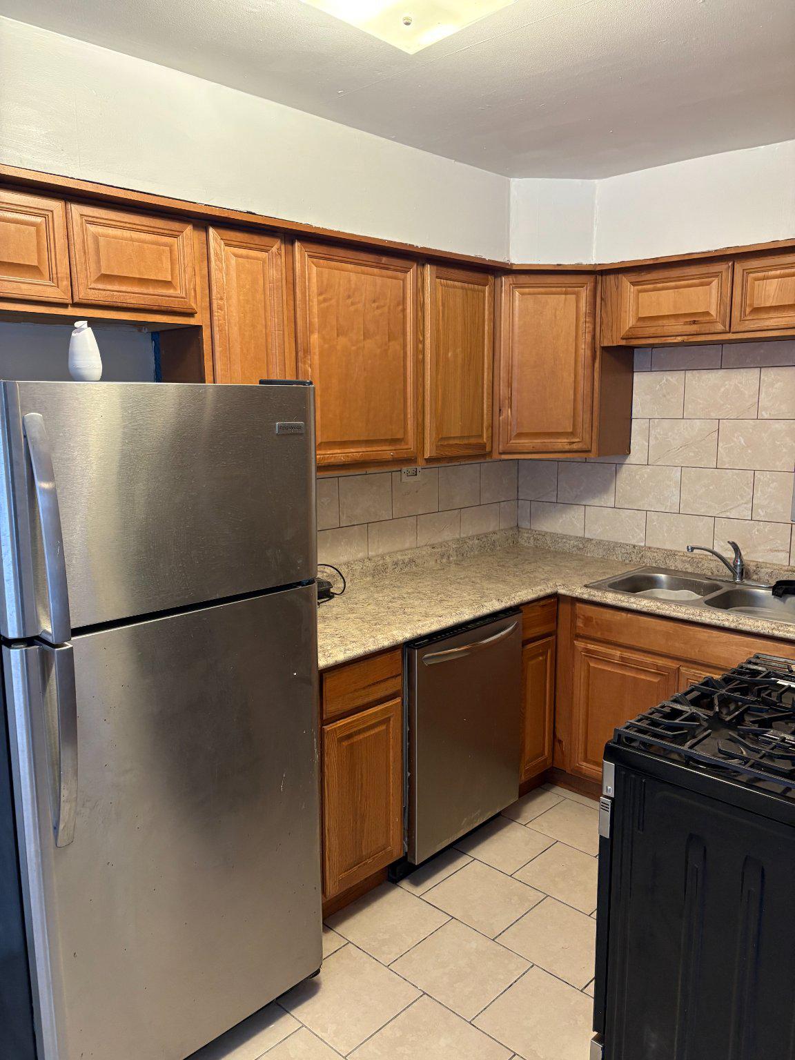 3419 Carter Lane Chester, PA 19013 - Photo 10 of 52 Unit 1 - Modern kitchen with warm wood tones.