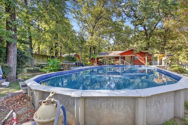 a view of a yard in front of a house with large tree